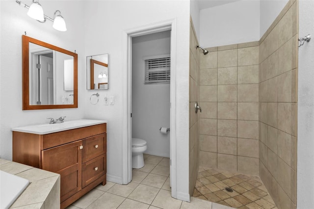 full bath with tile patterned flooring, a stall shower, toilet, and vanity