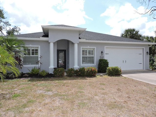 single story home with driveway, a front lawn, an attached garage, a shingled roof, and stucco siding