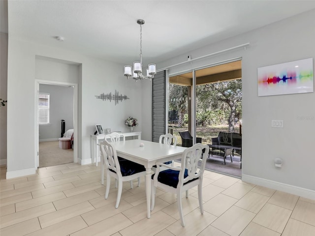 dining space with an inviting chandelier