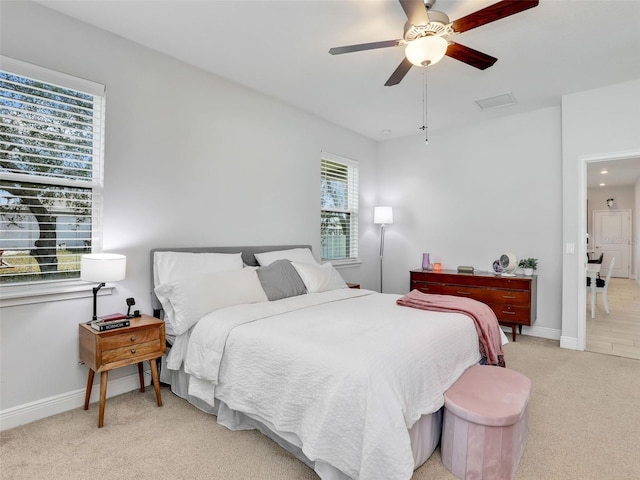 bedroom with ceiling fan and light colored carpet