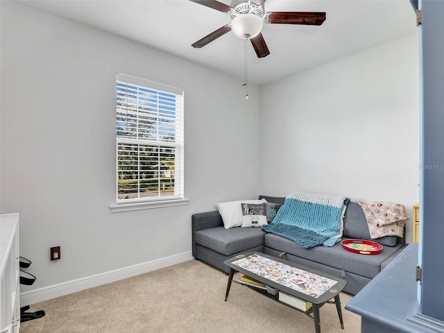 carpeted living room with ceiling fan