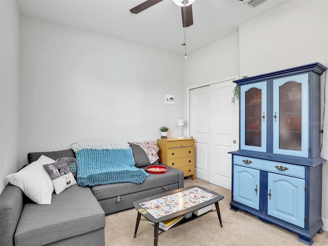 living room featuring light carpet and ceiling fan