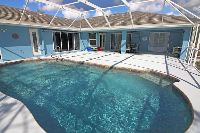 view of swimming pool with a patio and glass enclosure