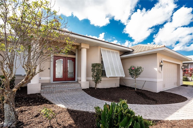 entrance to property with french doors and a garage