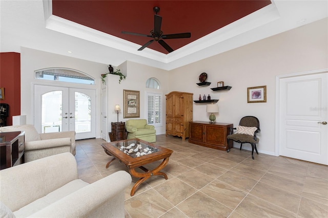 living room featuring light tile patterned floors, crown molding, ceiling fan, a tray ceiling, and french doors