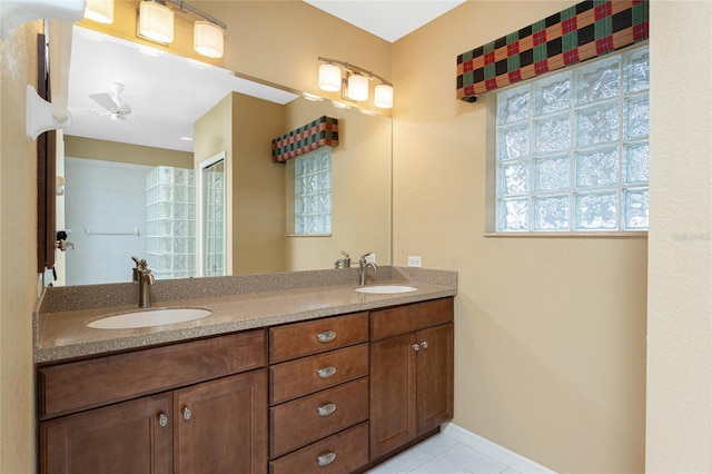 bathroom with tile patterned flooring, vanity, and ceiling fan