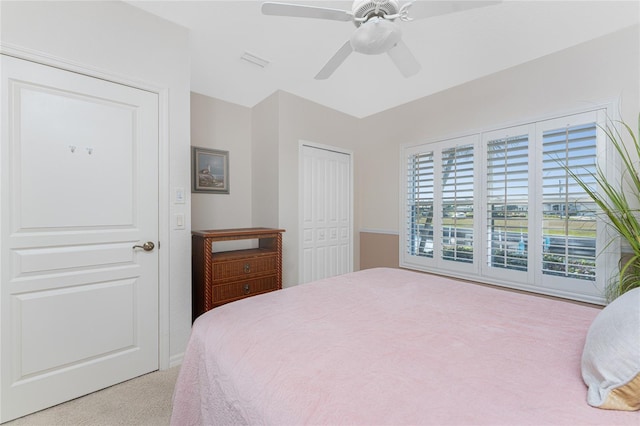 carpeted bedroom with ceiling fan and a closet