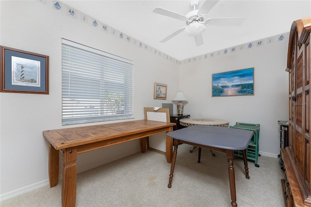 carpeted office space featuring ceiling fan