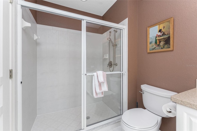 bathroom featuring vanity, toilet, and an enclosed shower