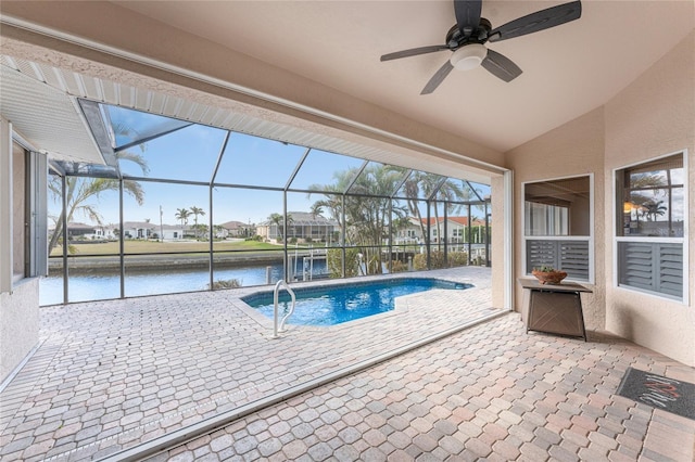 view of swimming pool with a water view, glass enclosure, and a patio area