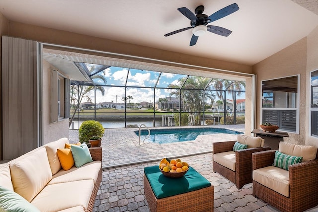 sunroom / solarium featuring a water view, a patio, outdoor lounge area, and ceiling fan