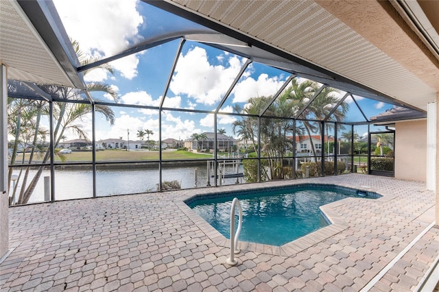 view of swimming pool featuring a water view, glass enclosure, and a patio area