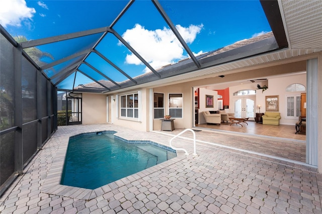 view of swimming pool featuring french doors, an outdoor hangout area, a patio, and a lanai