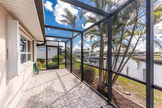 unfurnished sunroom with a water view