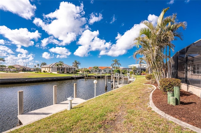 dock area featuring a water view and a yard