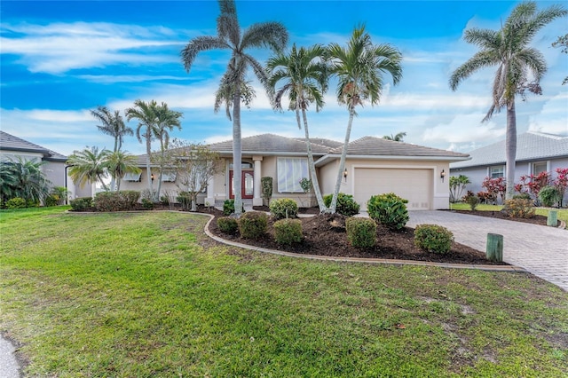 single story home featuring a garage and a front yard