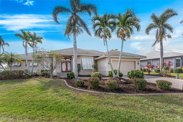 single story home featuring a garage and a front yard