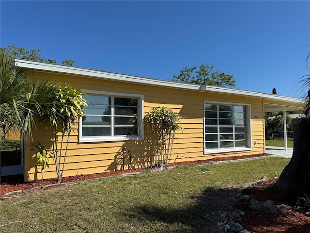 view of side of home featuring a yard