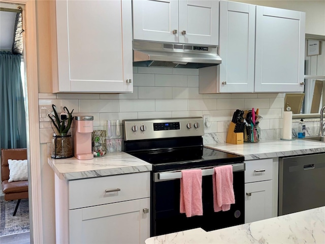 kitchen featuring white cabinetry, stainless steel appliances, and backsplash