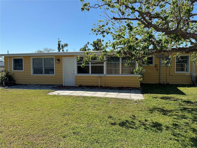 rear view of house with a yard and a patio area