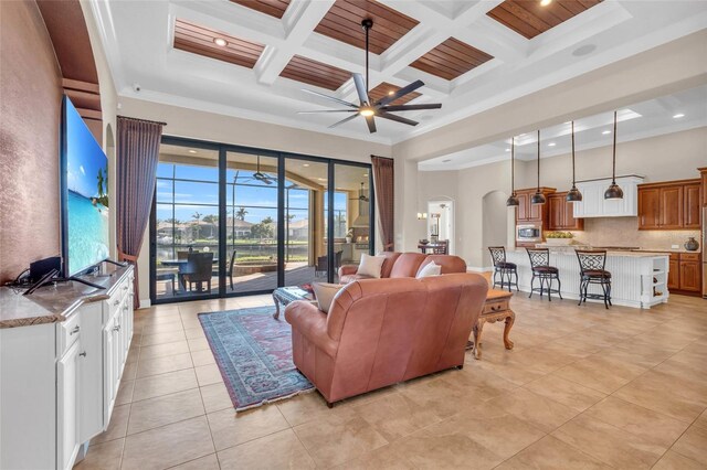 3321 Tripoli Blvd, Punta Gorda, FL 33950 - tiled living room with ceiling fan, ornamental molding, and a towering ceiling