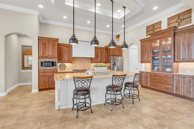 3321 Tripoli Blvd, Punta Gorda, FL 33950 - kitchen featuring pendant lighting, appliances with stainless steel finishes, a center island with sink, light stone countertops, and a kitchen bar