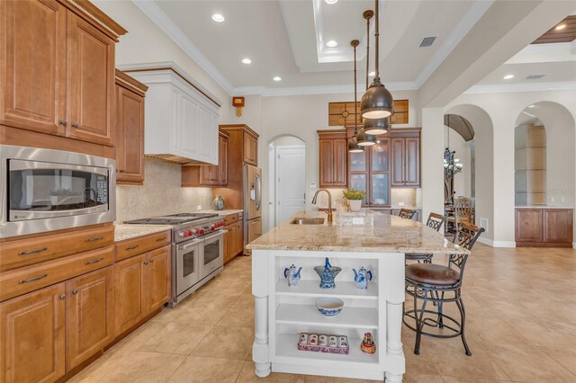 3321 Tripoli Blvd, Punta Gorda, FL 33950 - kitchen with pendant lighting, sink, appliances with stainless steel finishes, light stone countertops, and a center island with sink
