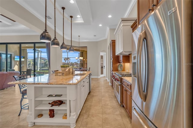 3321 Tripoli Blvd, Punta Gorda, FL 33950 - kitchen featuring pendant lighting, appliances with stainless steel finishes, light stone countertops, white cabinets, and a large island with sink