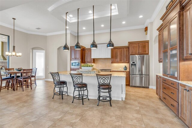 3321 Tripoli Blvd, Punta Gorda, FL 33950 - kitchen with a kitchen island, light stone countertops, appliances with stainless steel finishes, and a kitchen bar