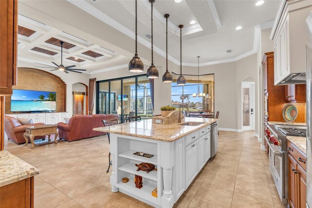3321 Tripoli Blvd, Punta Gorda, FL 33950 - kitchen with an island with sink, sink, white cabinets, hanging light fixtures, and stainless steel appliances