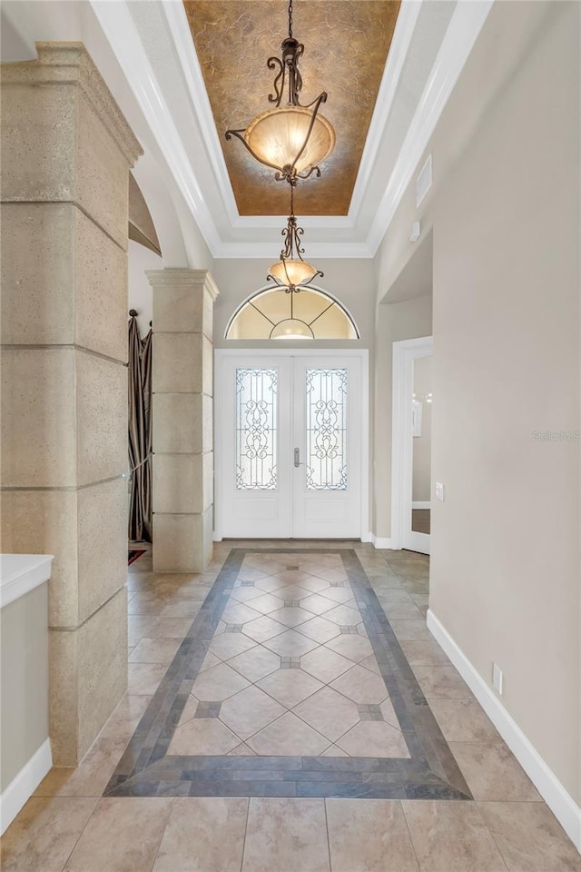 3321 Tripoli Blvd, Punta Gorda, FL 33950 - foyer featuring french doors, ornamental molding, a raised ceiling, and ornate columns