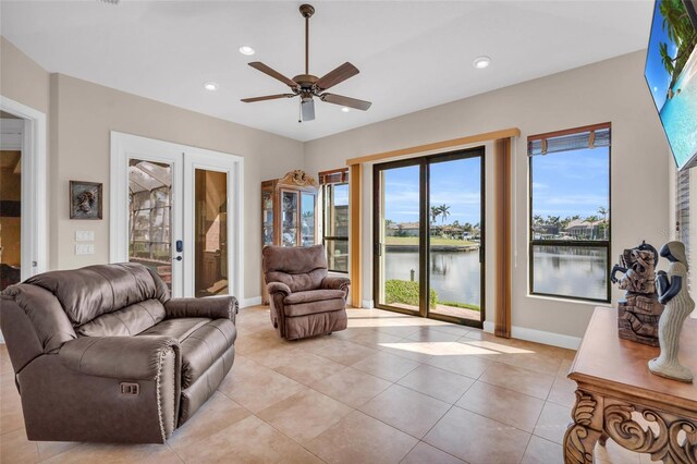 3321 Tripoli Blvd, Punta Gorda, FL 33950 - living room featuring a water view, light tile patterned floors, ceiling fan, and french doors