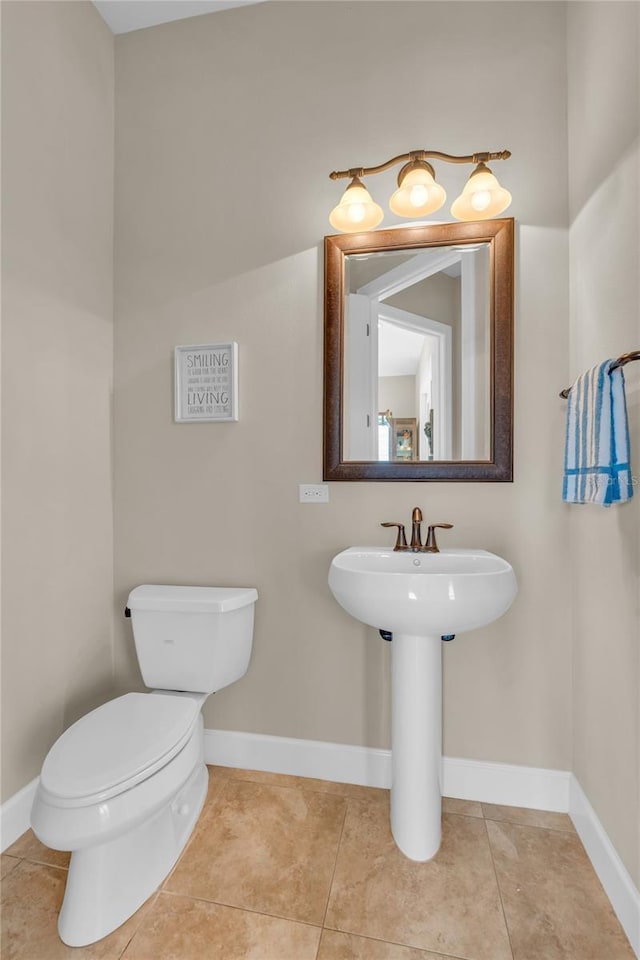 3321 Tripoli Blvd, Punta Gorda, FL 33950 - bathroom with tile patterned floors, toilet, and sink