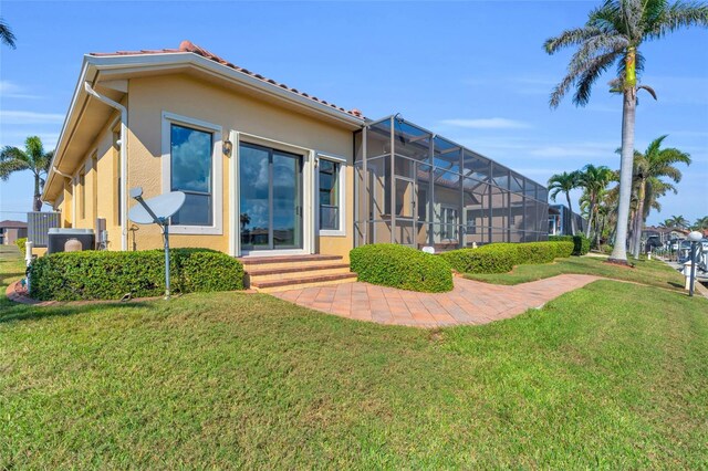 3321 Tripoli Blvd, Punta Gorda, FL 33950 - back of property with a yard and glass enclosure