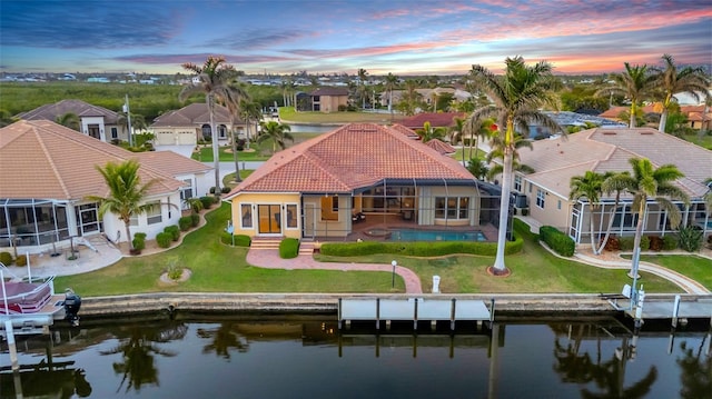 3321 Tripoli Blvd, Punta Gorda, FL 33950 - back house at dusk with a patio, a water view, and glass enclosure