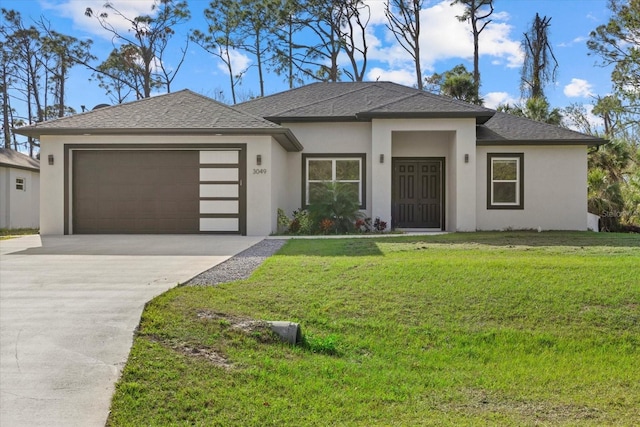 prairie-style house featuring a garage and a front yard