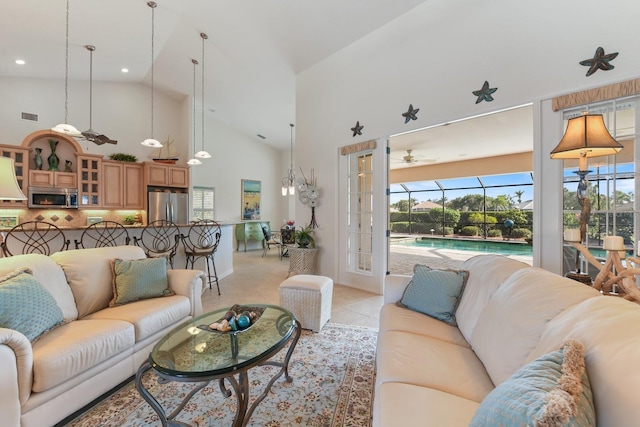 living room with light tile patterned floors, high vaulted ceiling, and ceiling fan