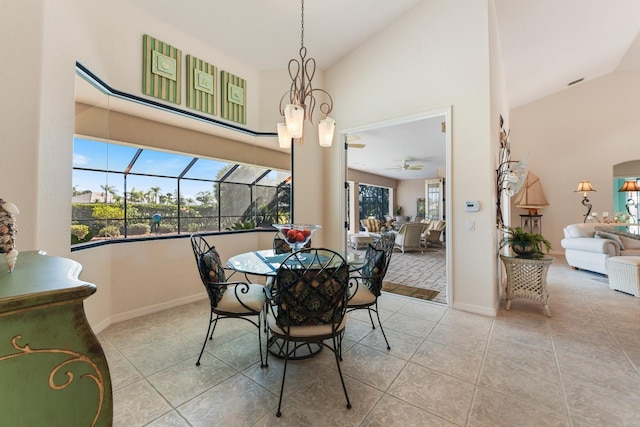 dining area featuring light tile patterned floors, high vaulted ceiling, and a healthy amount of sunlight