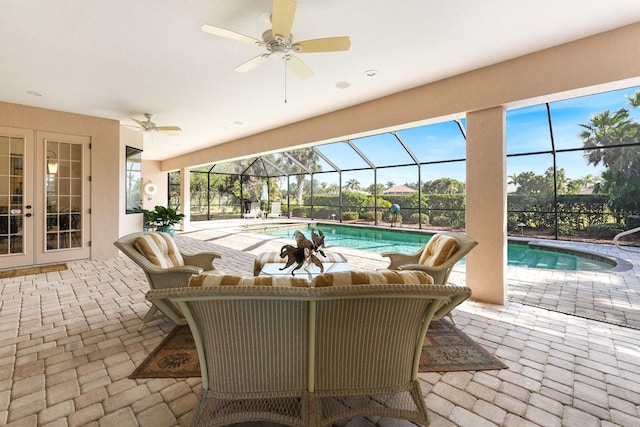 view of swimming pool featuring a patio area, french doors, ceiling fan, and glass enclosure