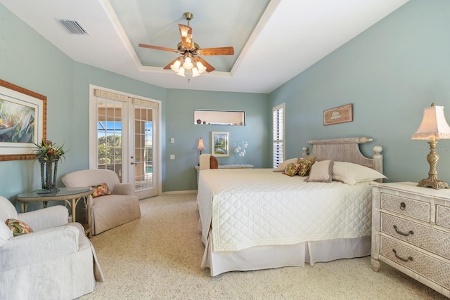 bedroom featuring a tray ceiling, access to outside, french doors, and ceiling fan