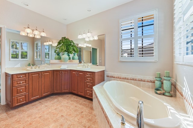 bathroom featuring vanity, tile patterned flooring, and a relaxing tiled tub