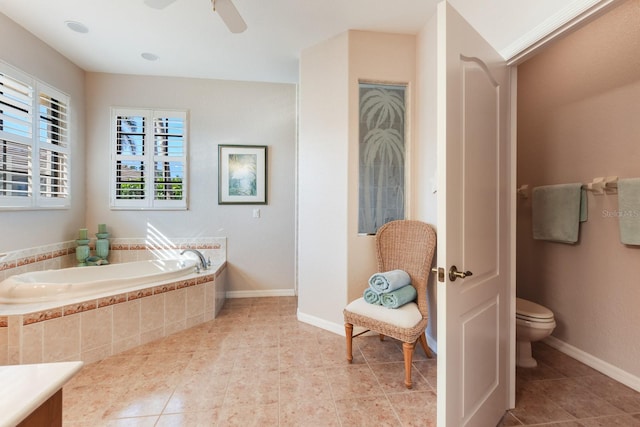 bathroom featuring ceiling fan, tile patterned floors, toilet, and tiled tub