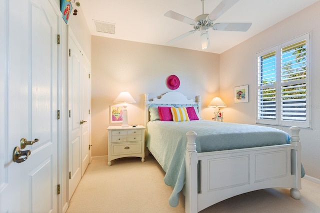 bedroom featuring light carpet and ceiling fan