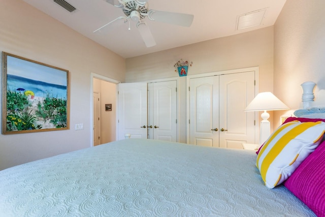 bedroom featuring multiple closets and ceiling fan