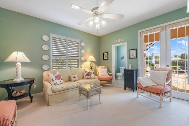 living room featuring carpet floors, ceiling fan, and french doors