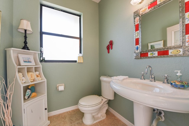 bathroom with tile patterned flooring and toilet