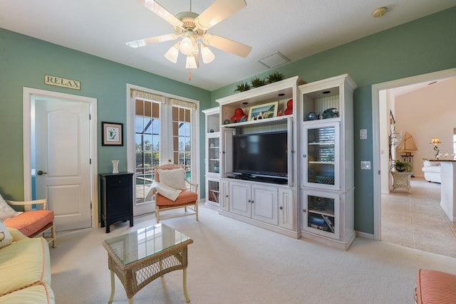 living room with ceiling fan and light carpet