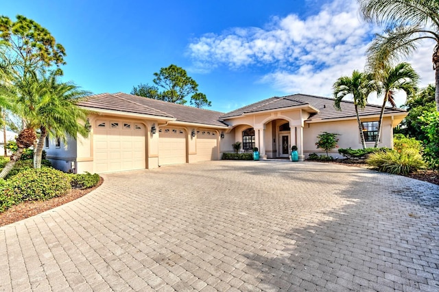 mediterranean / spanish-style house with a garage