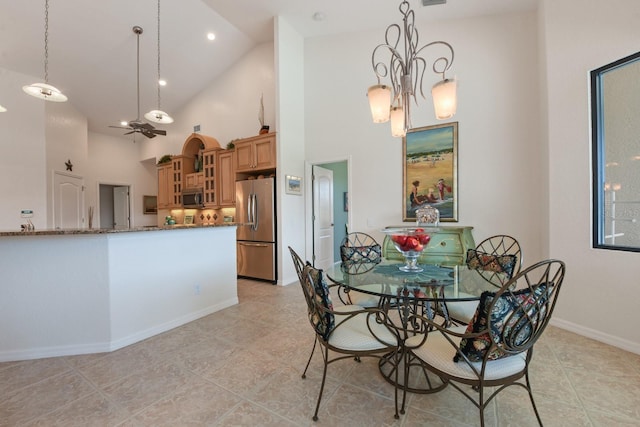 tiled dining space featuring high vaulted ceiling