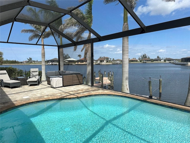 outdoor pool with a water view, glass enclosure, an outdoor living space, and a patio